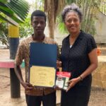 Man receiving certificate and gift from woman.