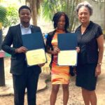 Three people holding certificates, smiling.